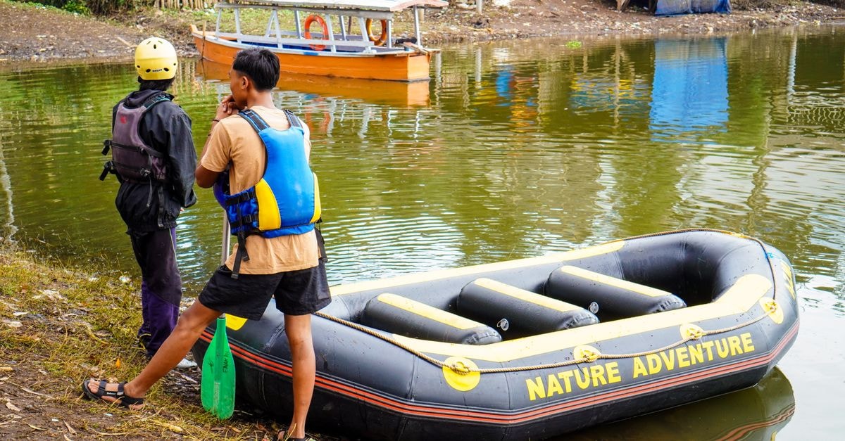 South Tangerang Travel Guide: Planning Tips, Costs and Things to Do Two people prepare for a river rafting adventure in West Java, Indonesia.