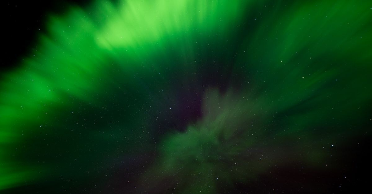 Aurora, Colorado Travel Guide: Neighborhoods, Green Spaces, and Easy Logistics Stunning green aurora borealis illuminating the starry night sky over Iceland.