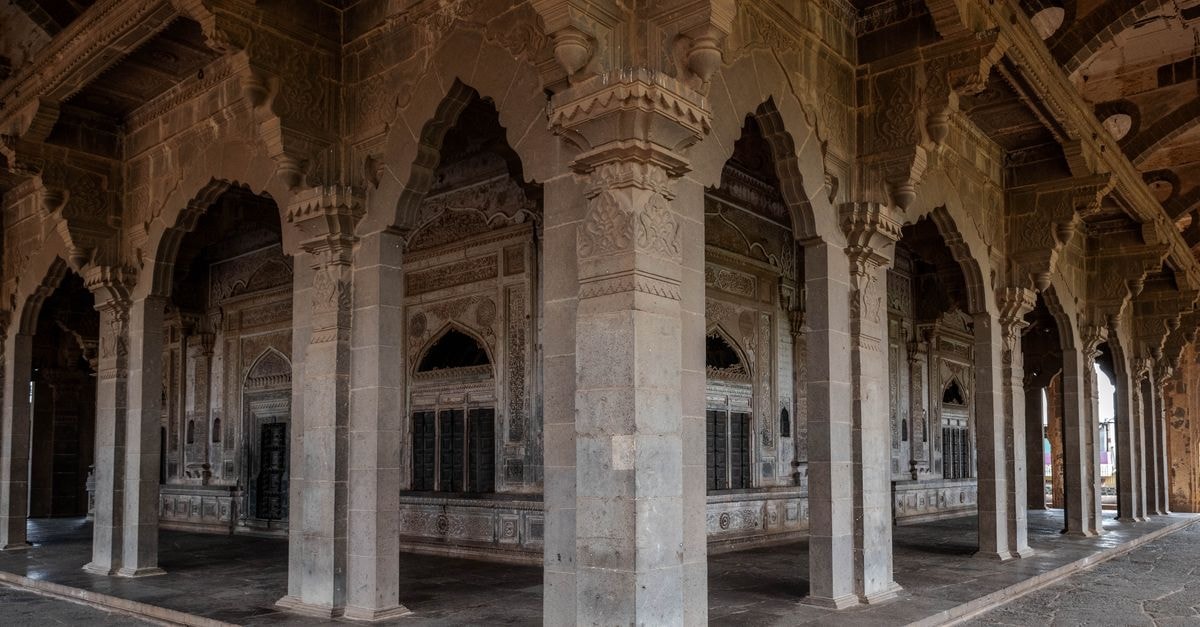 Hotel Megharaj, Bijapur — A Station Road Stay Near Gol Gumbaz A stunning view of intricate stone arches in the historic city of Bijapur, India.