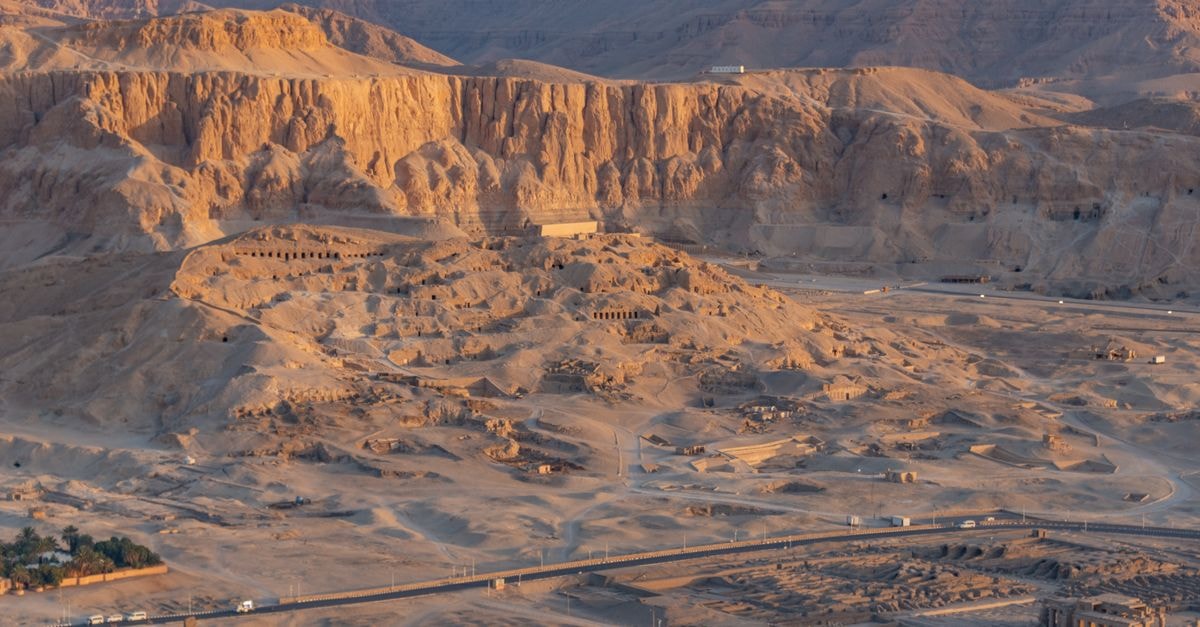 Breathtaking aerial shot of Luxor desert terrain showcasing ancient ruins at sunset.