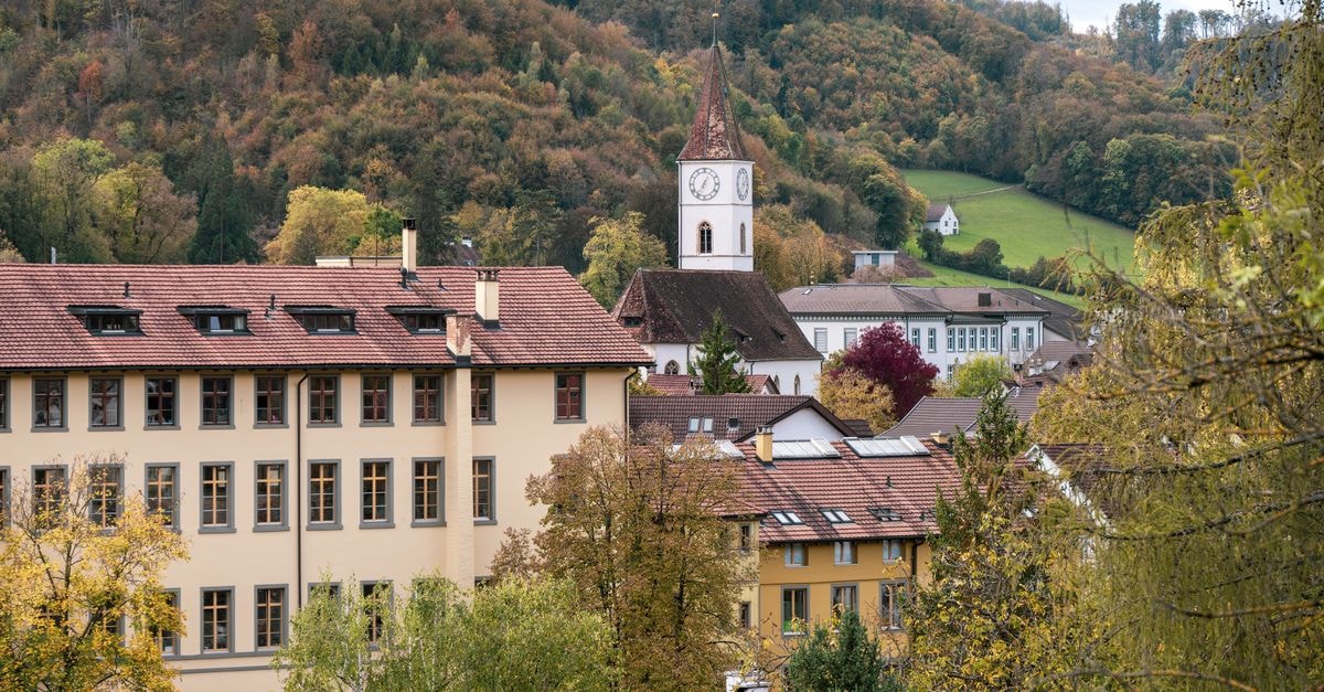 St. Gallen travel guide: a quiet Swiss city with culture on the doorstep Charming view of Sissach with St. Jakob Church tower surrounded by fall foliage.