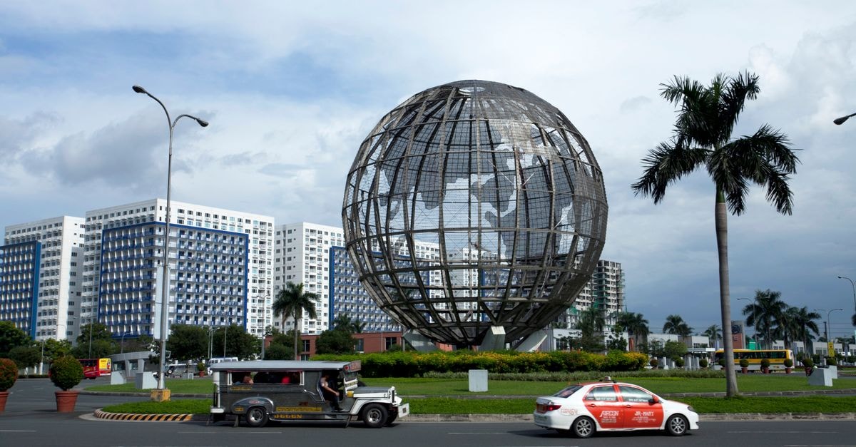 San Pablo City Travel Guide: Lakes, Rain and Easy Manila Access Large globe sculpture in Manila, capturing urban architecture and vibrant city life.