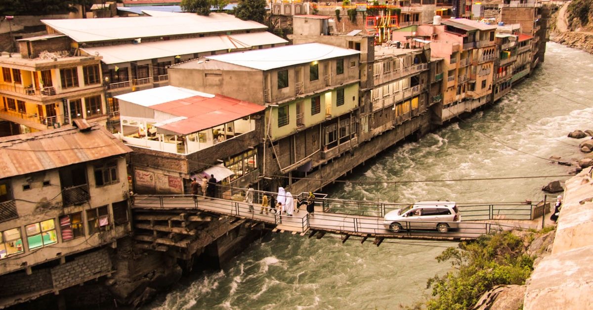 Picturesque view of a bridge over the Swat River in Bahrain, Khyber Pakhtunkhwa, Pakistan, capturing daily life.
