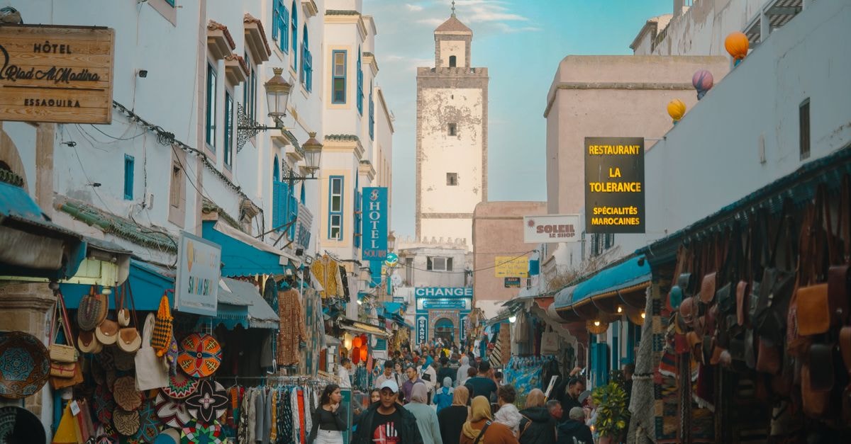Conakry Travel Guide: Atlantic Edge, Market Pulse Bustling scene of Essaouira's Medina street market, showcasing local trade and culture.