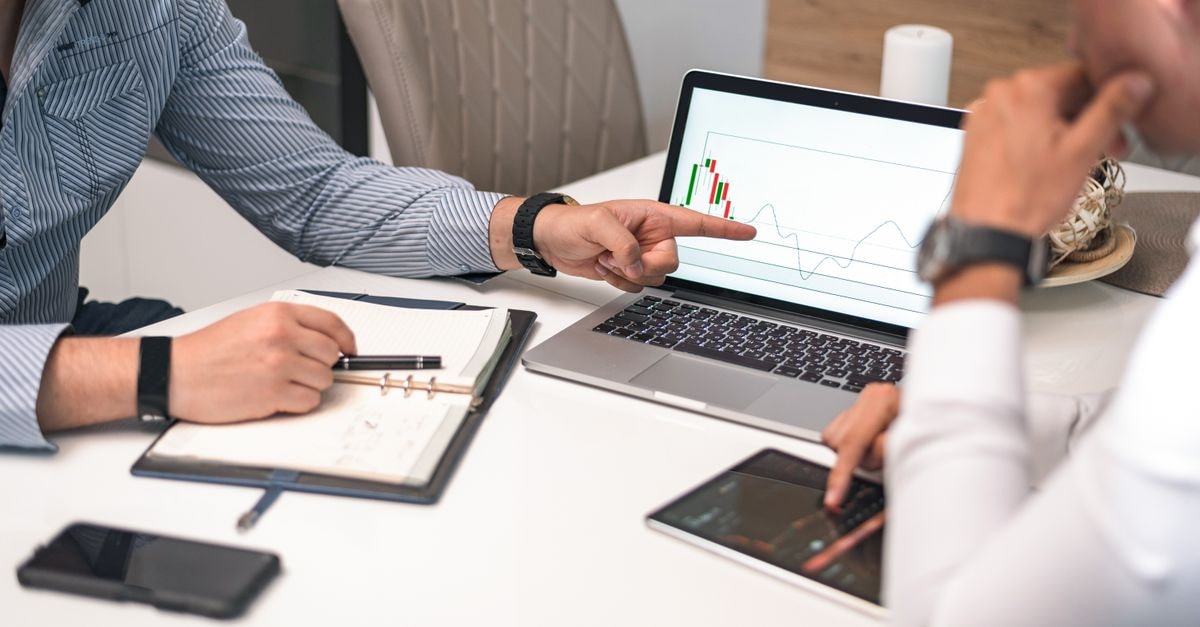 Morgan Stanley projects 50% DDR4 price surge in Q3 as memory makers prioritize HBM Two businessmen analyzing financial charts and data on a laptop and tablet.