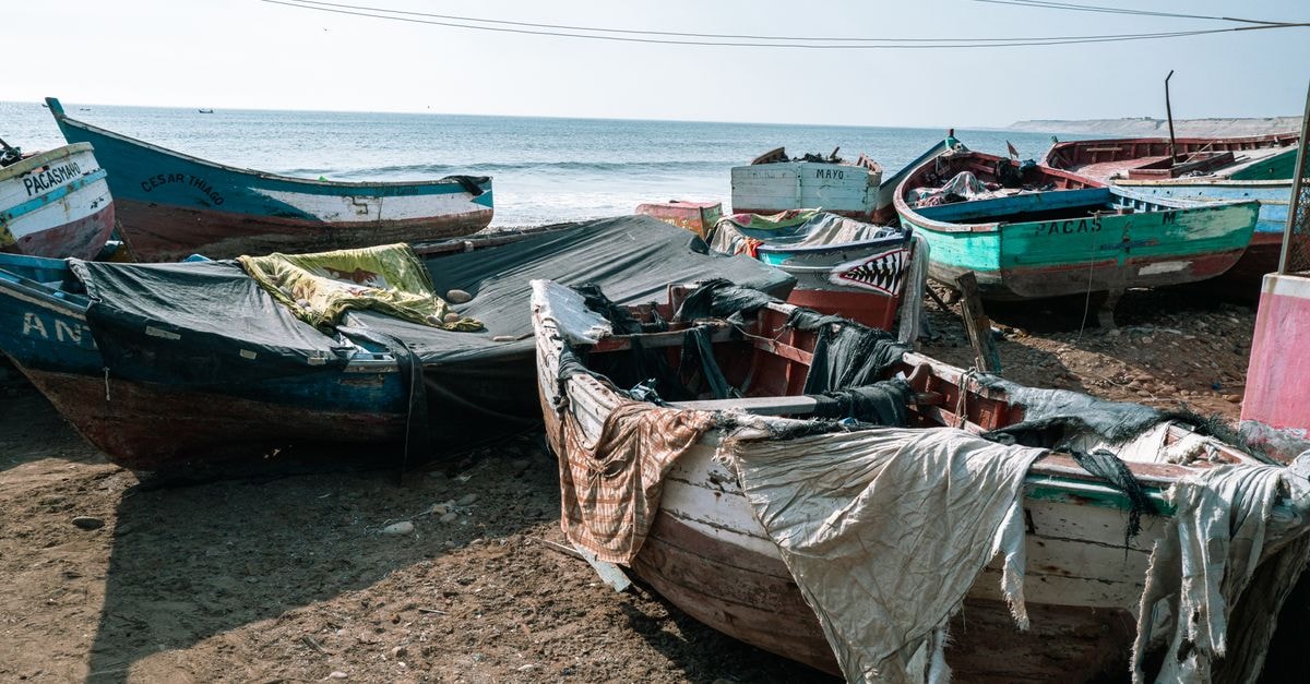 Old fishing boats on the sandy shores of Pacasmayo, capture the essence of coastal life in Perú.