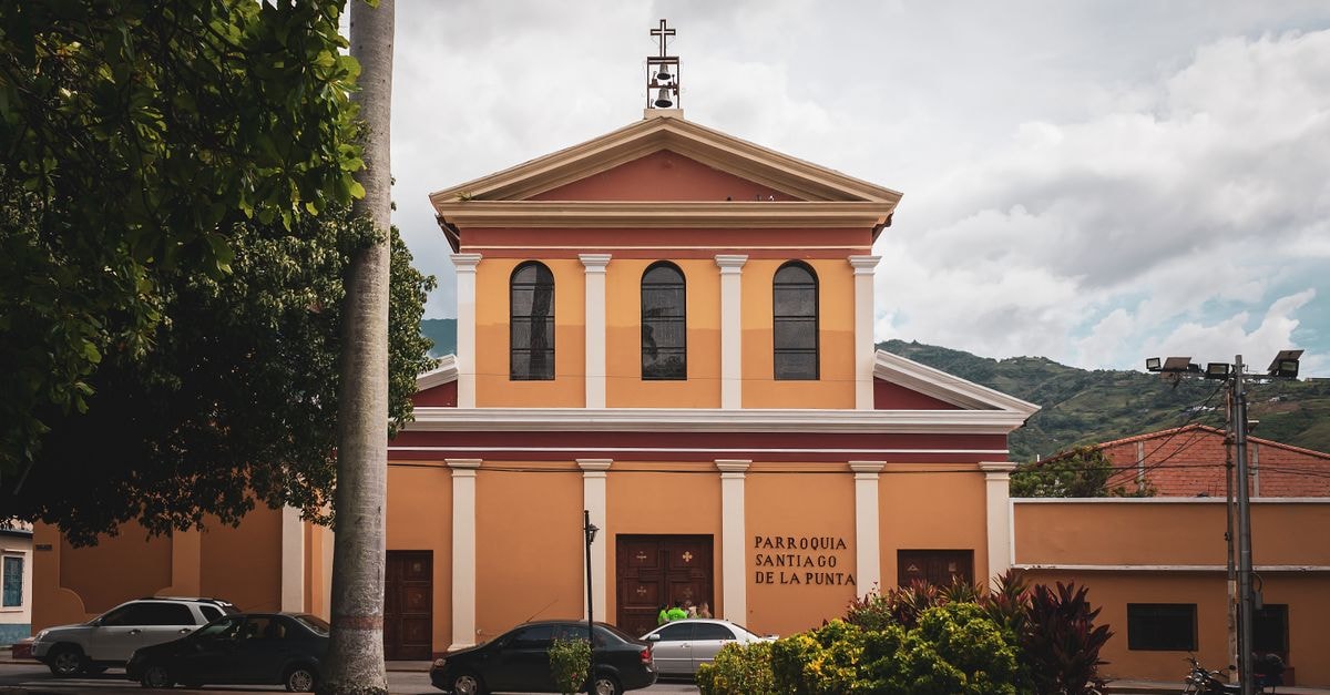 Soroca Travel Guide: Planning Tips, Costs and Things to Do Facade of Parroquia Santiago de La Punta against a cloudy sky in Mérida, Venezuela, showcasing classic architecture.