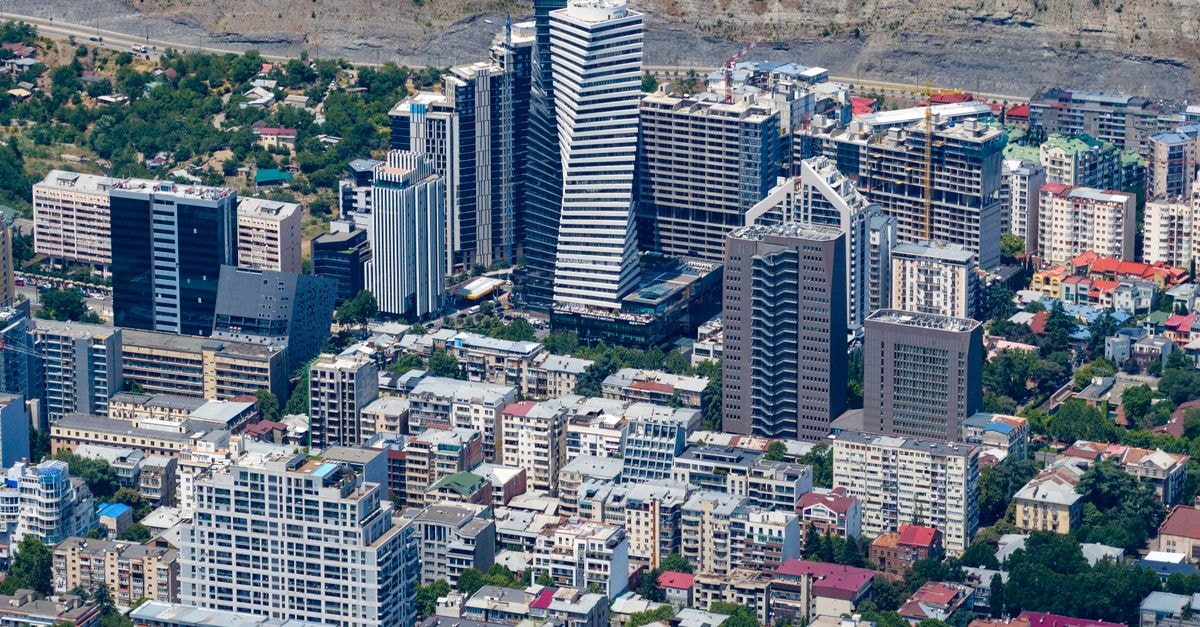 Stunning aerial view of Tbilisi's modern skyline featuring high-rise buildings and urban landscape.