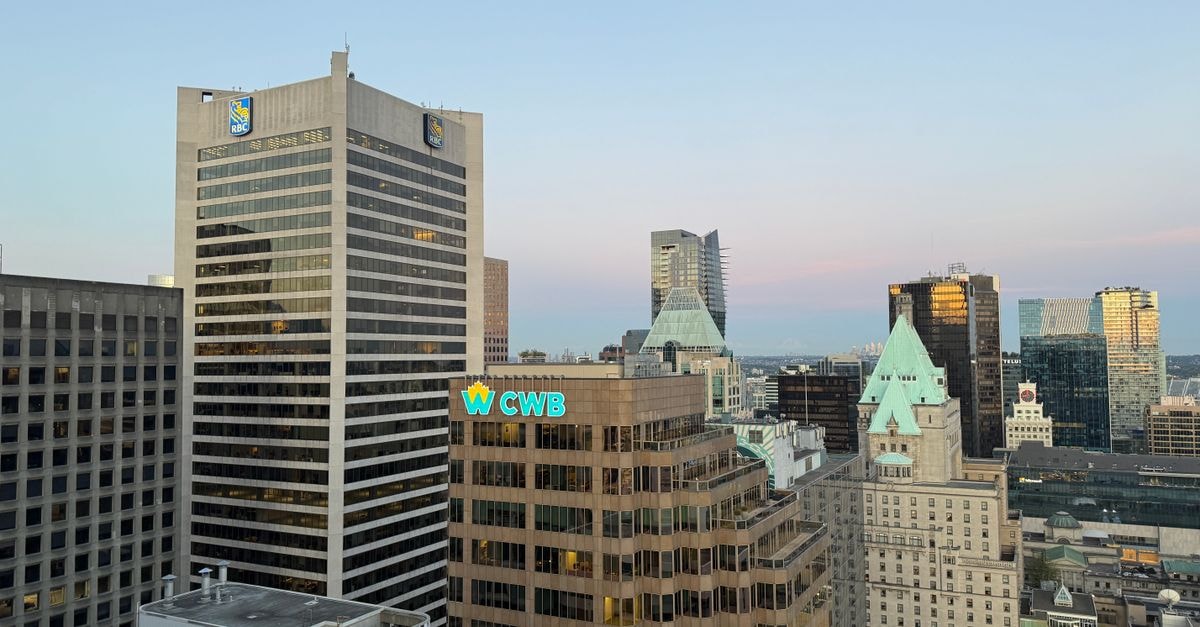 View of Vancouver city skyline featuring prominent office buildings and evening sky.