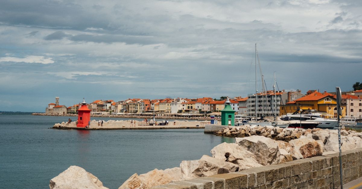 Piran Travel Guide: Slovenia's Little Piece of the Mediterranean Explore the vibrant coastline of Piran with its distinctive red lighthouse and charming architecture.