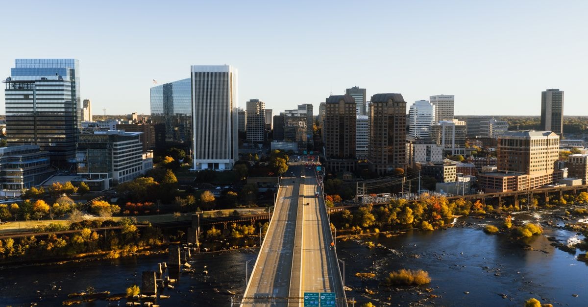 Motel 6 Arlington TX Entertainment District: Pet-Friendly Base Near AT&T Stadium Aerial view of Richmond, Virginia skyline with bridge and river at dusk showcasing city architecture.