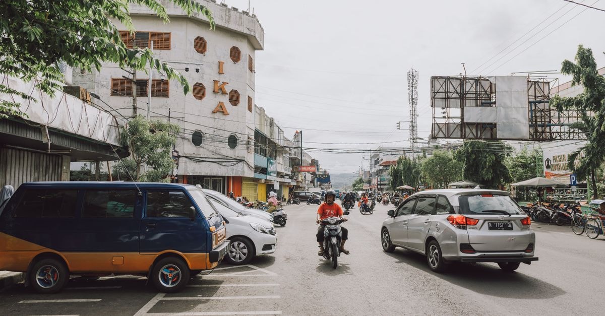 Hotel Tugu Malang: A Peranakan Antique Collection in Old Town Busy street scene in Malang, Indonesia, featuring traffic and local architecture.