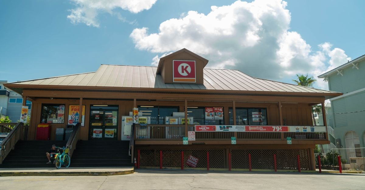 Suburban Propane Partners: Seasonal Distributor at a Market Price That Looks Stretched Suburban convenience store entrance with seated biker on a sunny day with blue skies.