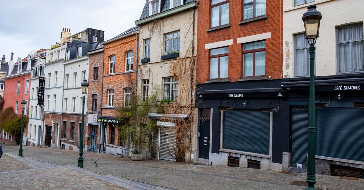 Lille Travel Guide: Getting Around and Eating Well Scenic view of a quiet cobblestone street lined with historic European houses.