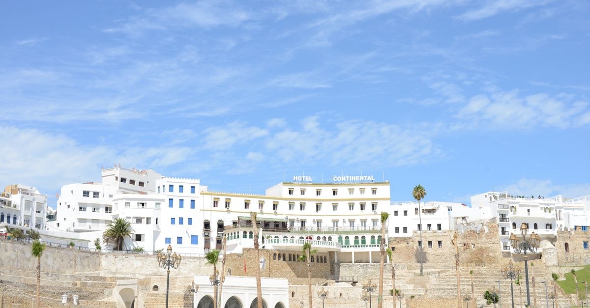 Tétouan Travel Guide: Medina Lanes and Coastal Calm View of the historic Hotel Continental against the blue sky in Tangier, reflecting Moroccan architecture.