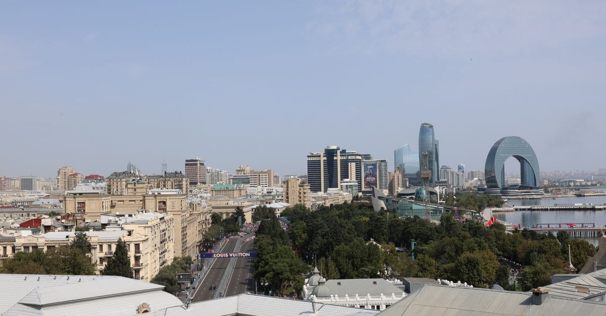 Aerial view of Baku featuring unique modern architecture and buildings against a clear blue sky.