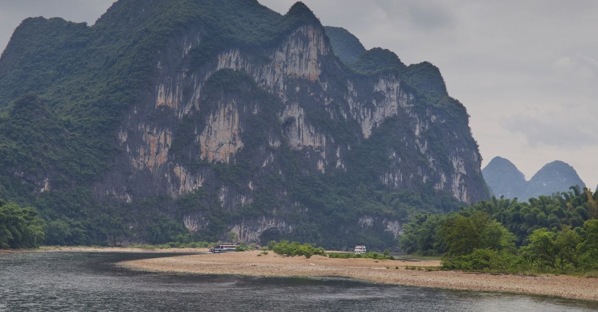 Wulong Travel Guide: Karst Canyons, Cool Escapes and Mountain Flavors Majestic karst mountains by the Li River showcasing natural beauty in China.