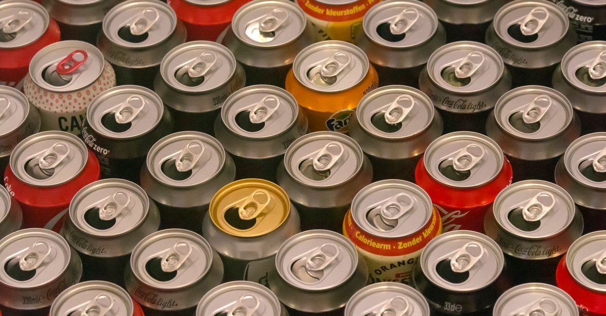 Coca-Cola raises Diet Coke prices in India over 10% as Iran conflict disrupts aluminum can supply Top view of various aluminum soda cans lined up in colorful rows, highlighting recycle potential.