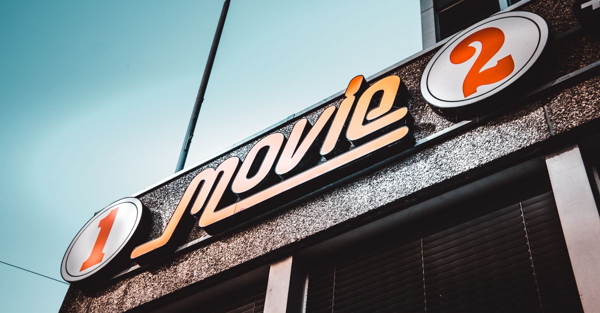 Hollywood horror reboots and Indian tentpoles dominate July 24 film news Low-angle shot of a vintage movie theater sign in Bern, Switzerland with a clear blue sky.
