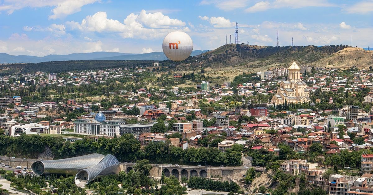 Guest House Umbrella in Tbilisi: A Recorded Address in the Georgian Capital A breathtaking aerial photograph of Tbilisi featuring iconic landmarks and lush surroundings.