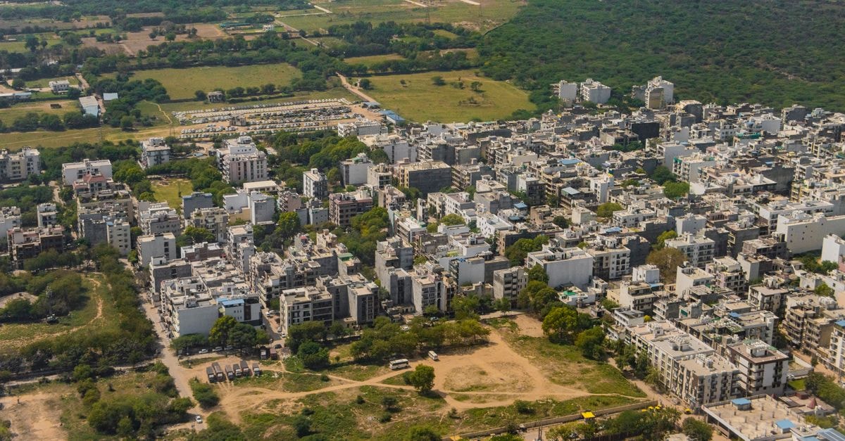 Stunning aerial view of Gurugram, India's vibrant urban landscape and green surroundings.