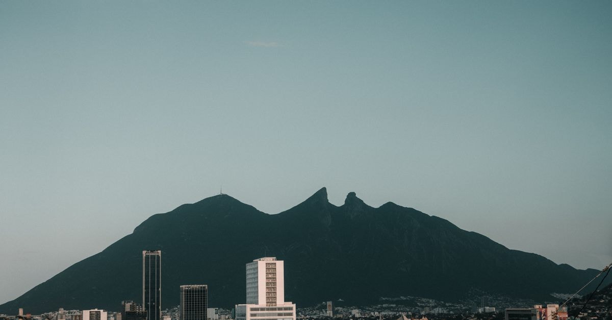 A stunning view of Monterrey cityscape with the iconic Cerro de la Silla mountain in the background.
