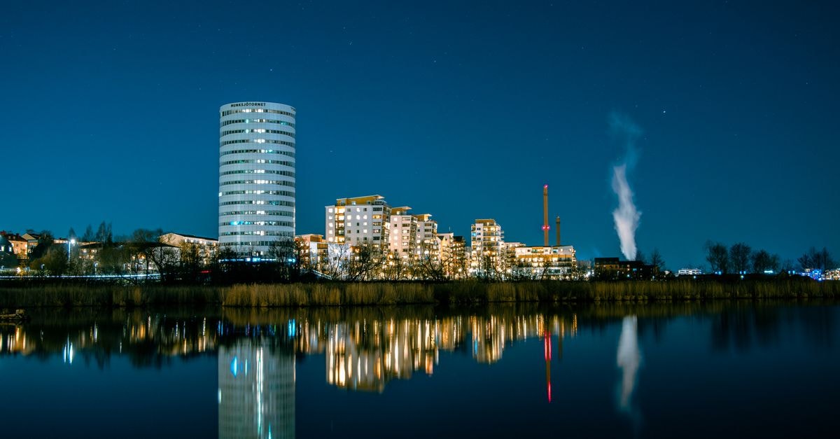 Scandic Lahti City, Lahti — Steps from Trio and the Train Station Stunning night view of Jönköping cityscape with building reflections on water.
