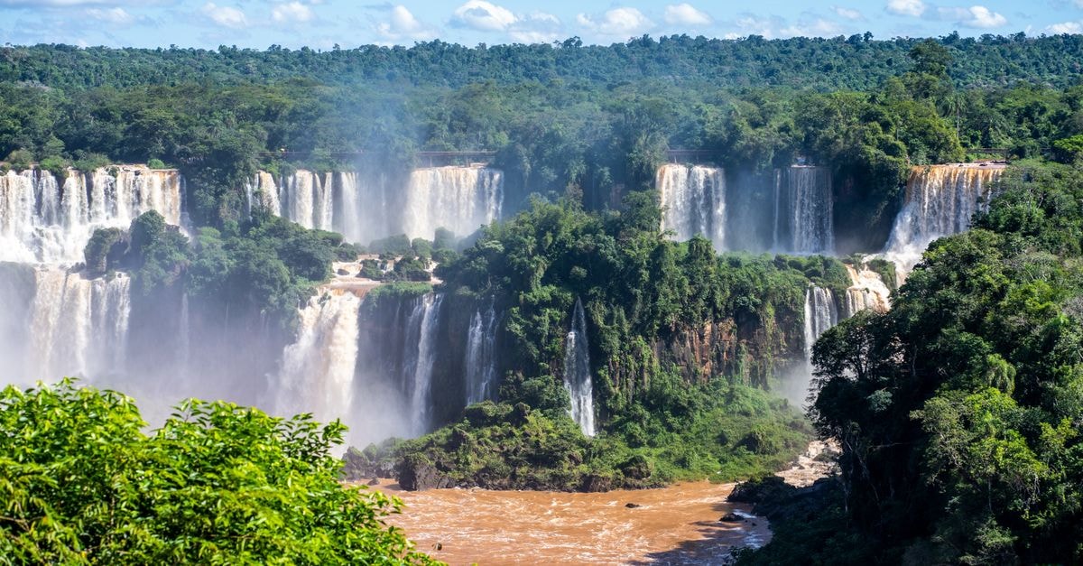 Nova Iguaçu Travel Guide: Planning Tips, Costs and Things to Do Stunning daylight view of Iguazu Falls with lush greenery and cascading waterfalls.