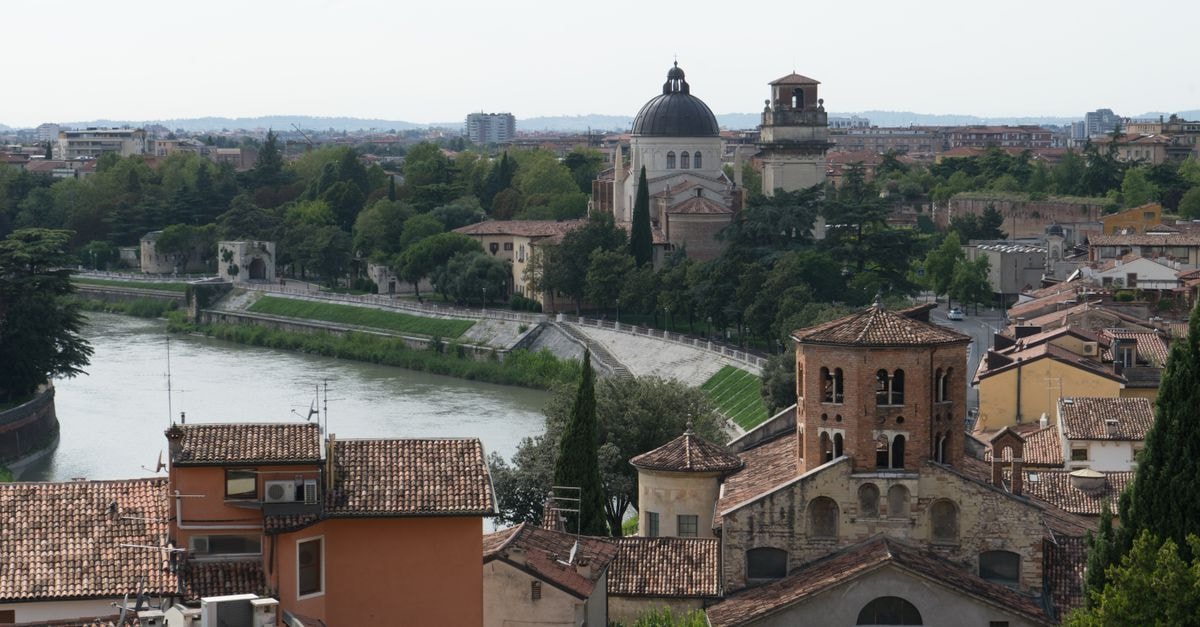 Hotel Bologna in Verona: A Quiet Piazzetta Overlooking Piazza Bra Panoramic view of Verona featuring San Giorgio in Braida and Santo Stefano along the Adige River.