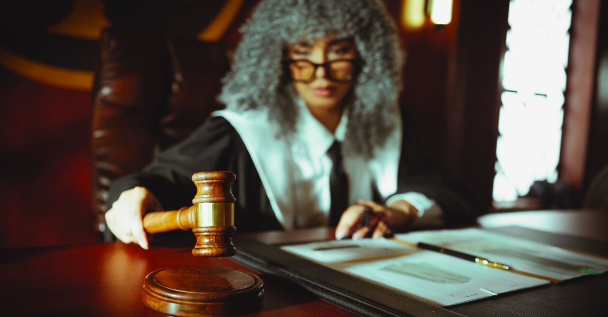 NFL tells justices prediction markets are gambling, backs states' push to regulate Kalshi A judge in a courtroom holding a gavel, focused on legal documents.