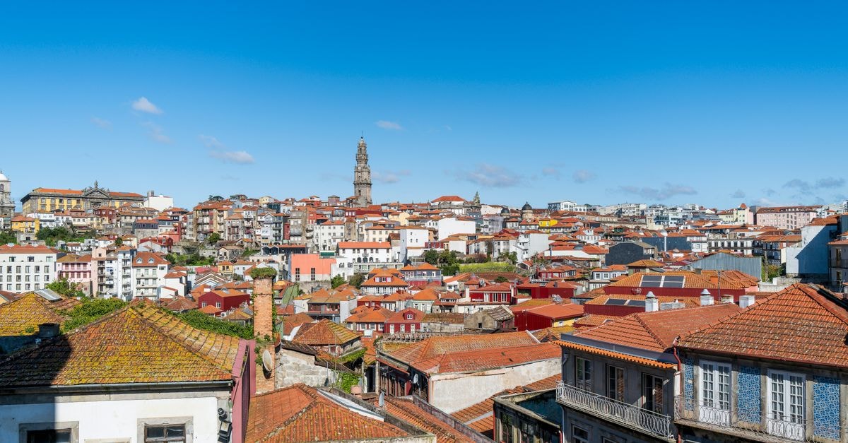 Hotel Libertador in Loja: A Heated-Pool Stay Near Puerta de la Ciudad Captivating aerial view of Porto's historic architecture and vibrant red rooftops against a clear blue sky.