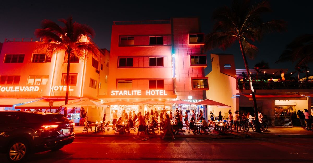 Street view of lively nightlife at the illuminated Starlite Hotel in an urban setting.