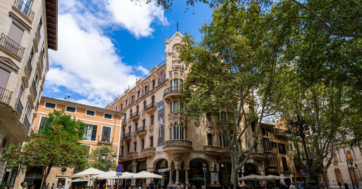 Palma de Mallorca Travel Guide: July 2026 Tips for Weather, Food & Sights Beautiful Art Nouveau building in Palma de Mallorca during a sunny day.