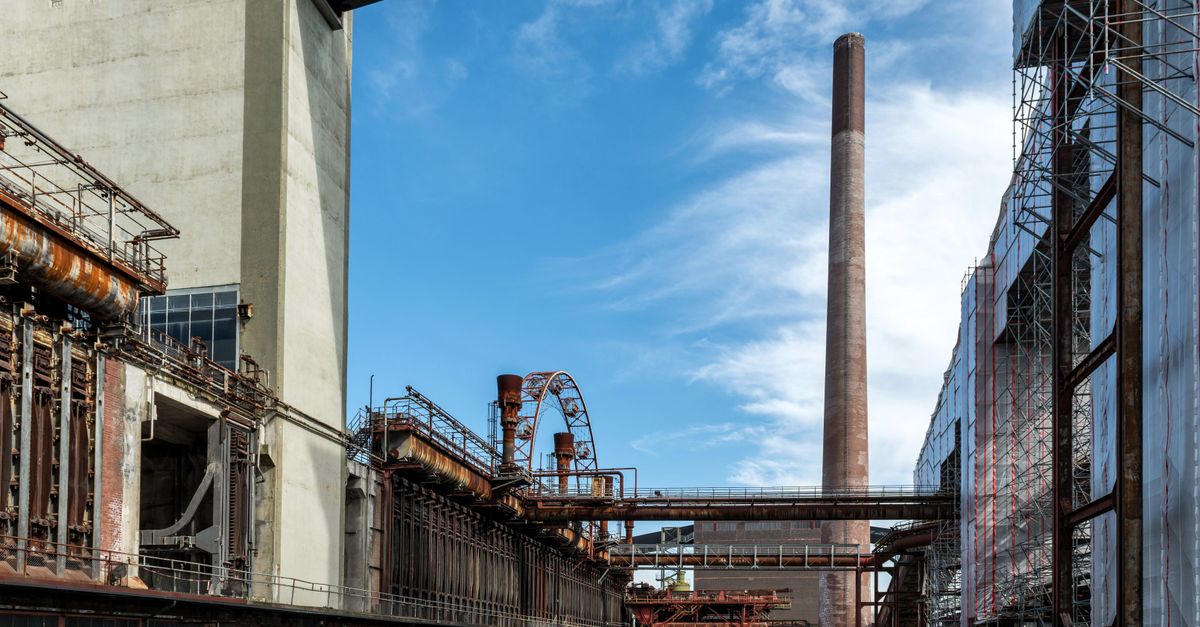 Steel Markets Diverge as China Demand Drifts Lower, US Mills Reap Q2 Profits, SAIL Eyes Coal Cost Relief View of Zollverein industrial site, showcasing historical steel architecture under a clear blue sky.