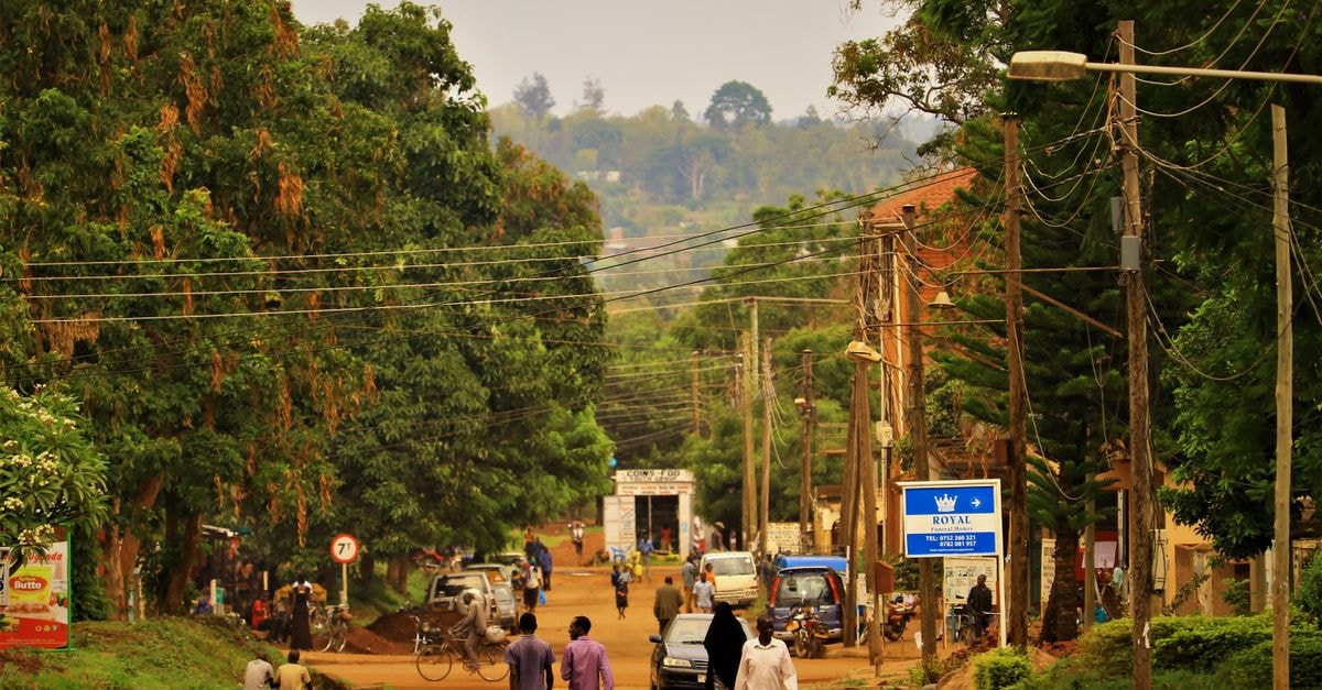 Kisii Travel Guide: Planning Tips, Costs and Things to Do A vibrant street scene capturing daily life in Uganda with people and vehicles.