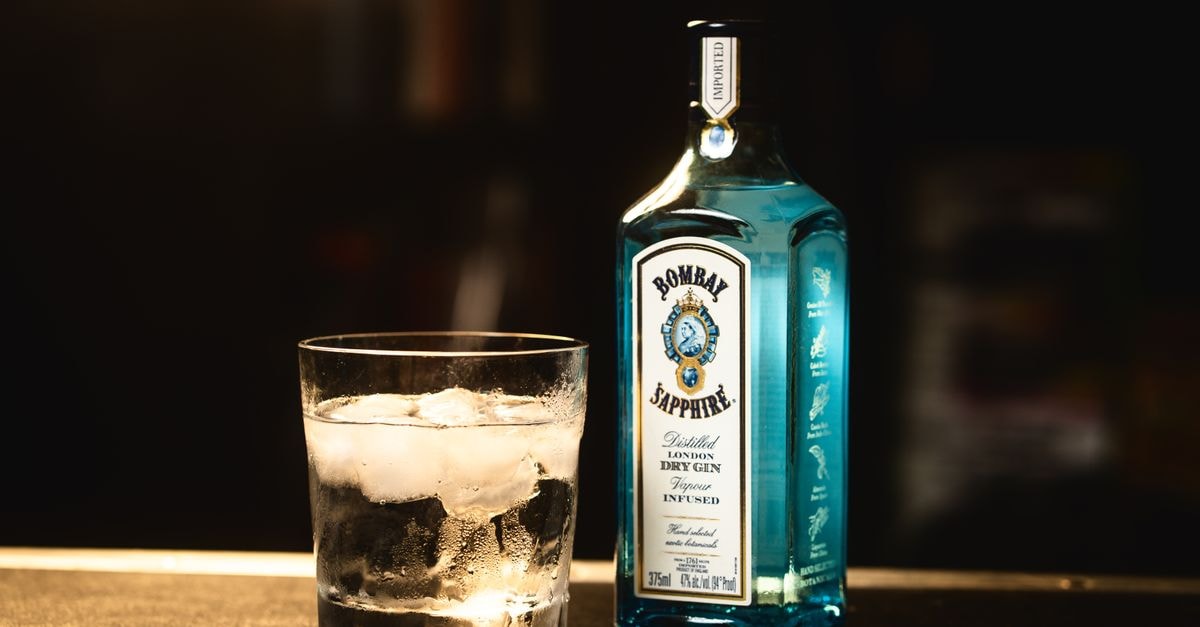 Paychex: Premium-Quality Compounder at a Premium Price Chilled Bombay Sapphire gin bottle beside a glass of ice cubes, perfect for cocktails.