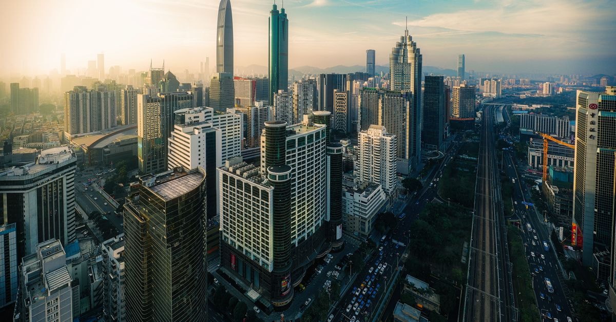 Hilton Shenzhen Futian in Shenzhen: Skyline Hub on Shennan Boulevard Aerial view of contemporary megapolis with tall modern glass buildings against cloudy sky