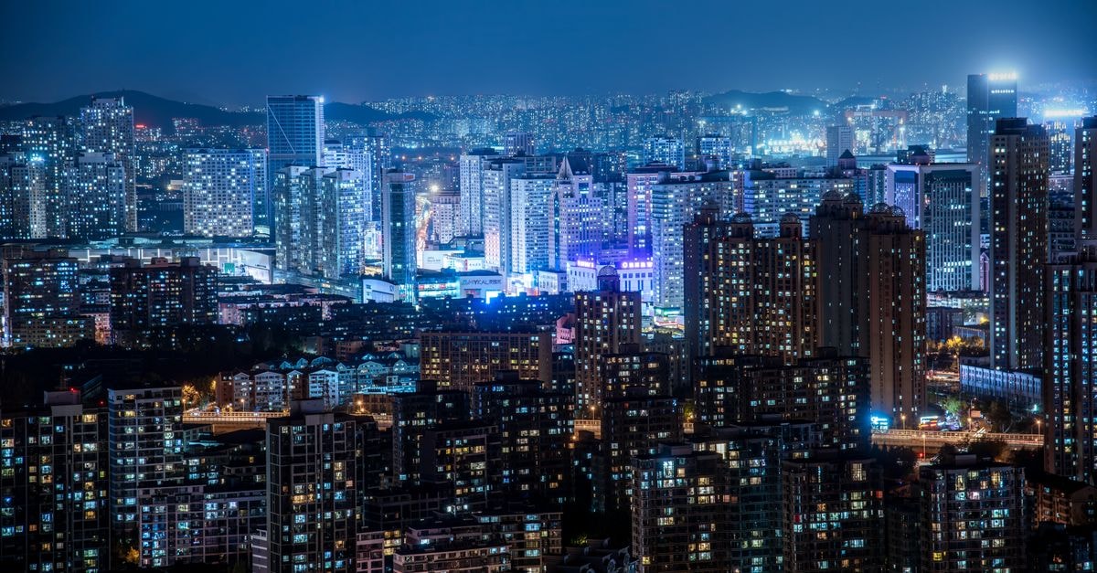Sinhungsan Hotel in Hamhung: Downtown Stay With a Noted Restaurant A stunning cityscape at night featuring illuminated skyscrapers and modern urban architecture under a clear sky.