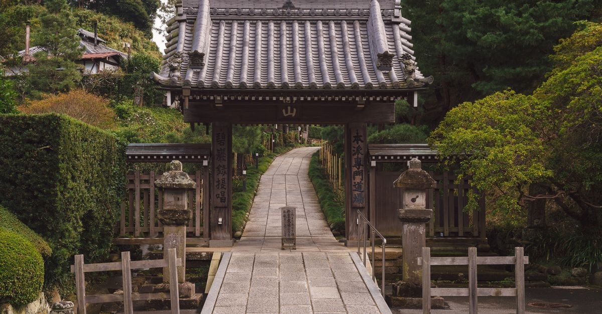 Hotel New Kamakura in Kamakura: A Taisho-Era Wooden Stay Explore the serene pathway leading to a traditional Japanese gate at Kencho-Ji Temple in Kamakura.