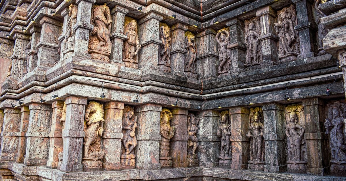 Brahmapur, Odisha: a slow travel guide to the silk city Detailed stone carvings on a Hindu temple facade in Chandipur, showcasing ancient artistry.