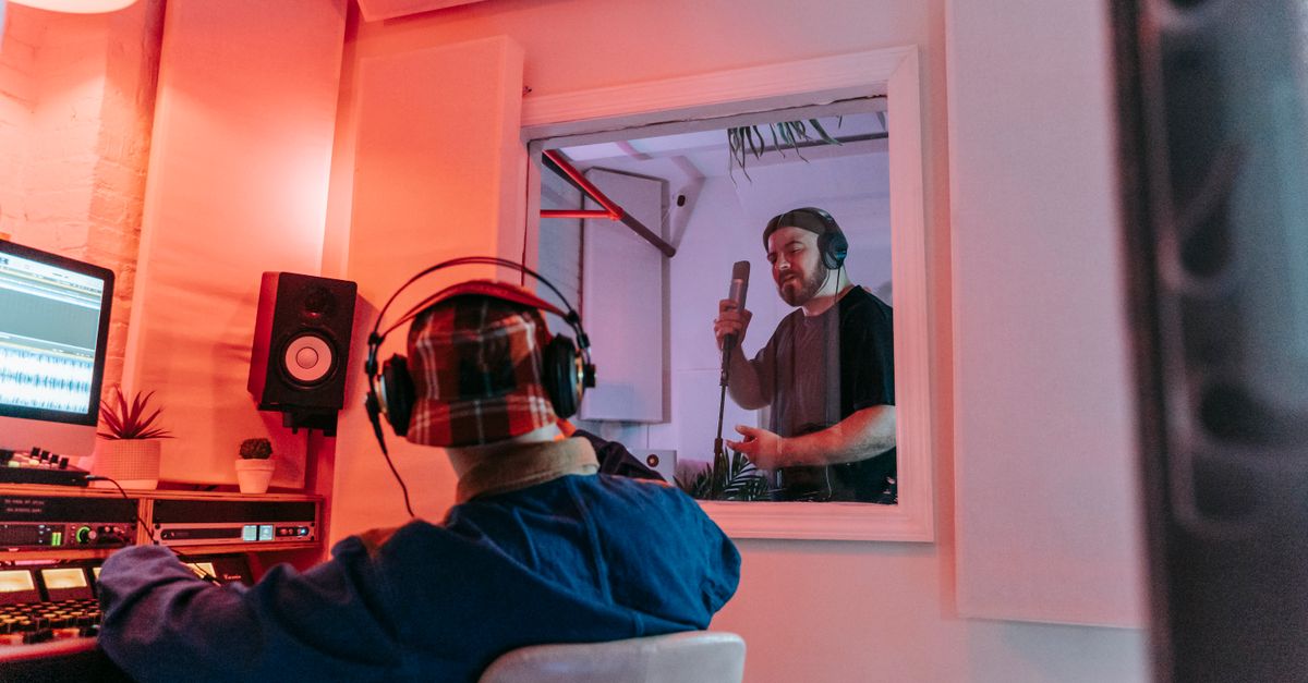 Tones And I, Melanie C and Richard Marx Join Revamped 'The Voice Australia' Coaching Panel Audio engineer and singer collaborating in a modern recording studio environment.