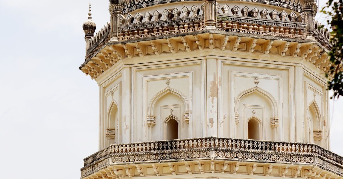 Slow Days in Guntur: A Travel Guide to River Drives and Old Landmarks Close-up of a beautifully detailed historical minaret showcasing intricate architectural designs.