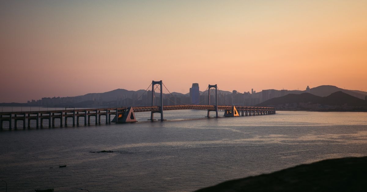 Spring Hotel, Dalian — A Central Stay Near Renminguangchang Explore the scenic beauty of Dalian's Xinghai Bay Bridge bathed in sunset light.