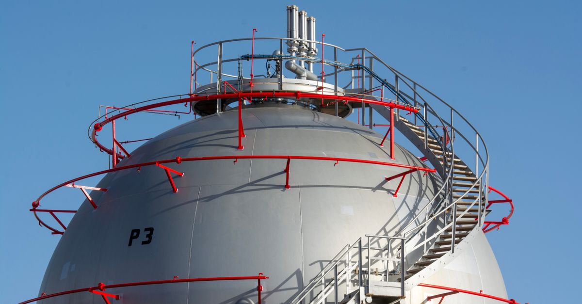 Close-up view of a large industrial gas storage sphere with a surrounding metal staircase.
