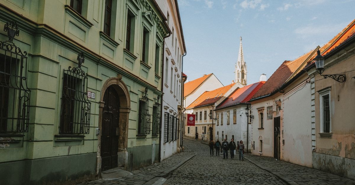 Košice, Slovakia: A Slow Travel Guide to a Gothic City of Cafés and Cobblestones Charming cobblestone street in Old Town Bratislava with historic architecture and pedestrians.