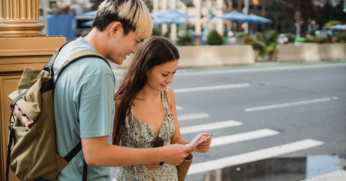 York Travel Guide July 2026: Sights, Events and Practical Tips for a Summer Visit Positive couple standing on city street while travelling together and searching route with map