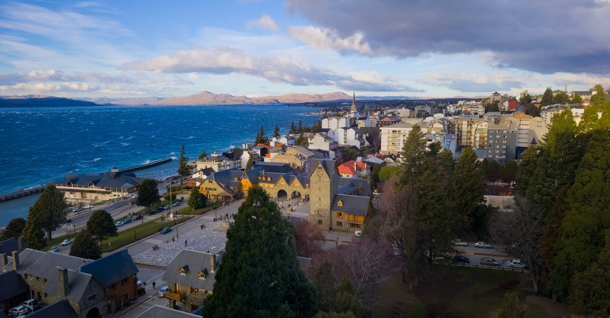 A breathtaking aerial view of San Carlos de Bariloche, capturing the vibrant turquoise lake and charming architecture.