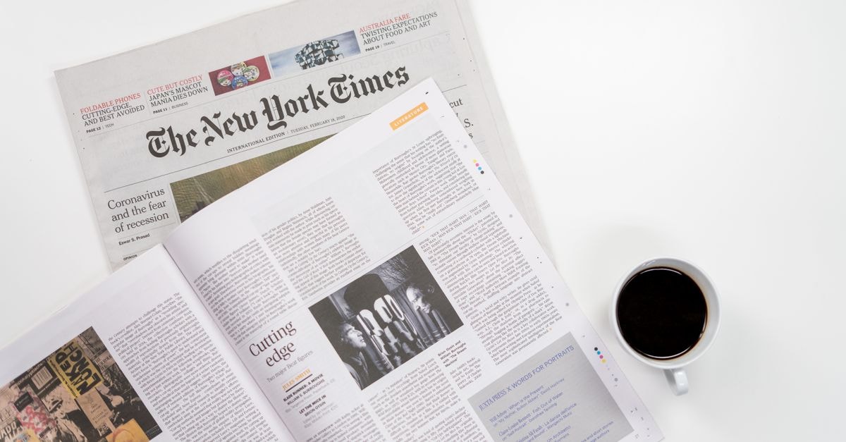 Flat lay of a coffee cup and The New York Times newspaper, ideal for business and lifestyle themes.