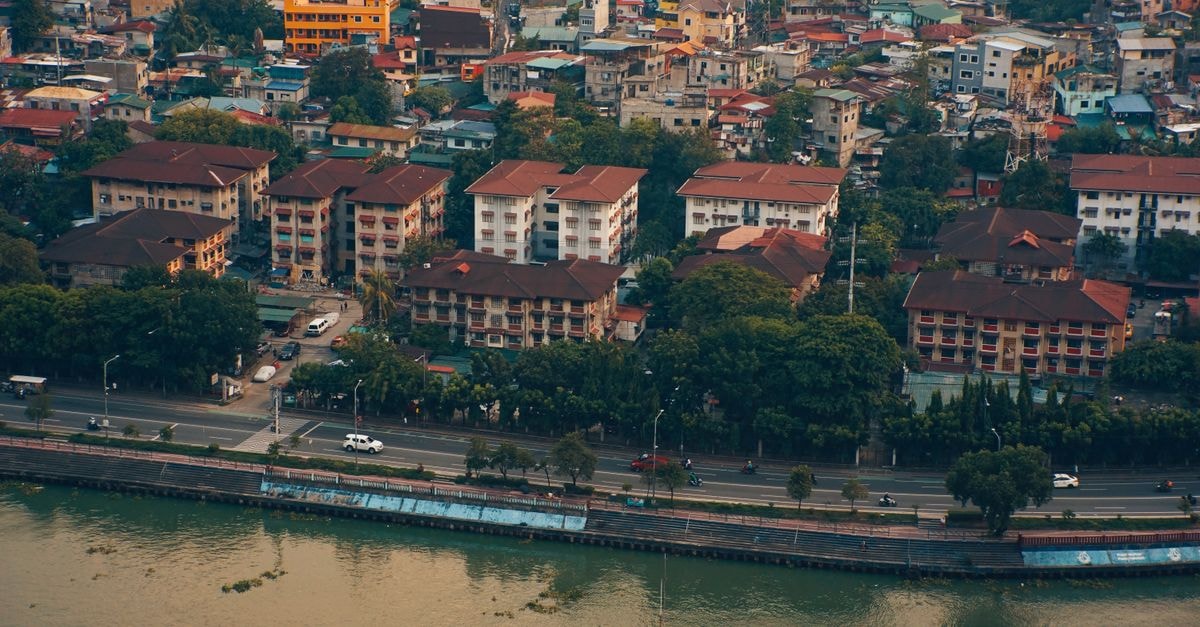 Aerial shot of urban cityscape with colorful buildings and waterfront view, showing urban living.