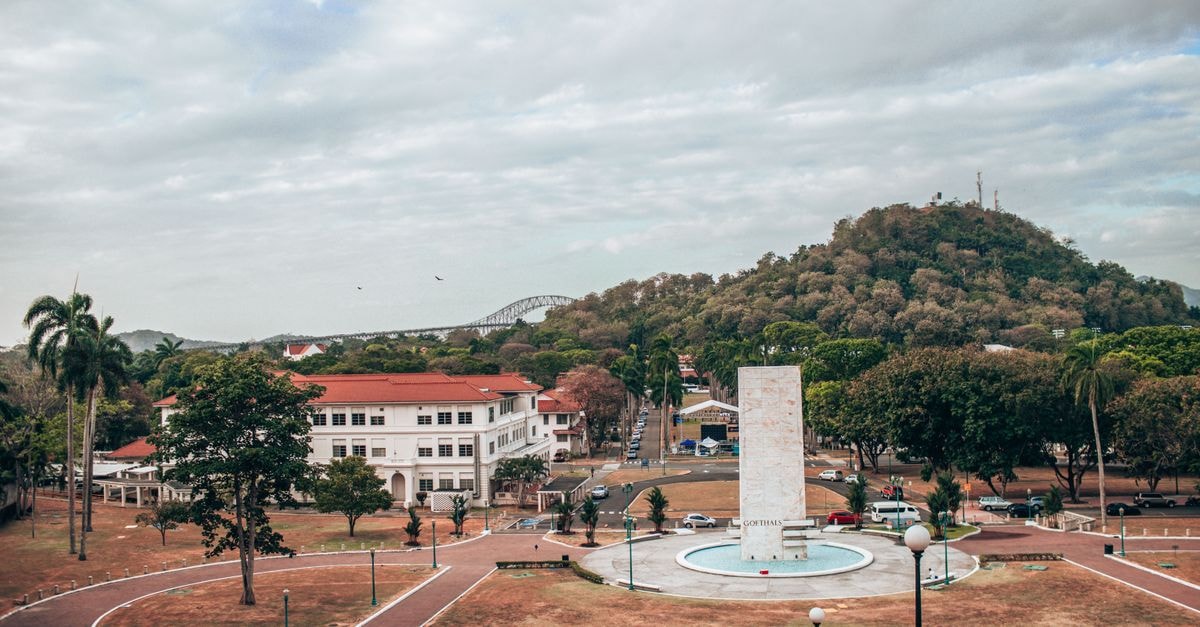 Radisson Colón 2,000 Hotel & Casino in Colón: Steps from the Cruise Port and Free Zone Aerial view of Balboa Park featuring a prominent monument and lush greenery under a cloudy sky.